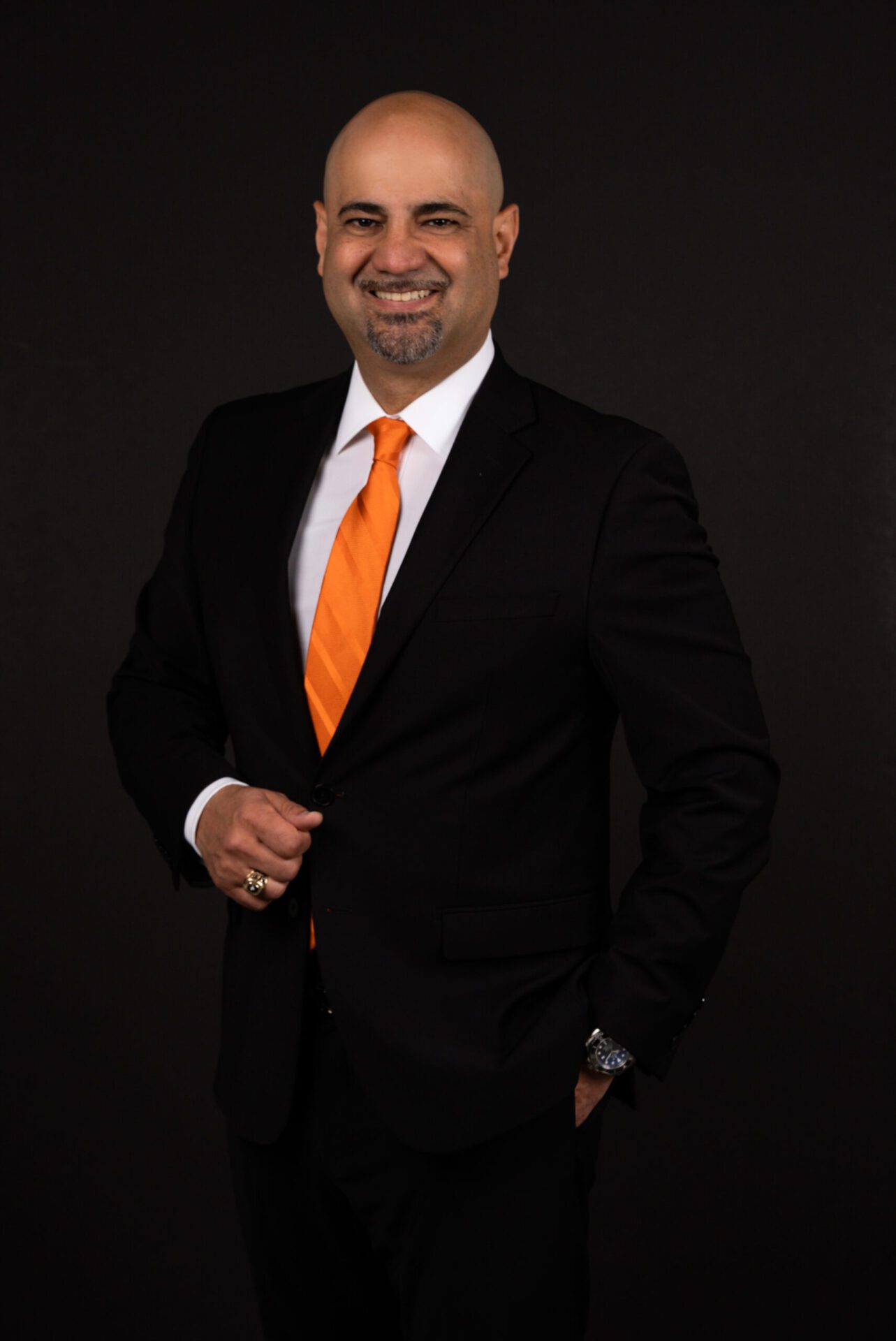 A man in a suit and tie posing for the camera.